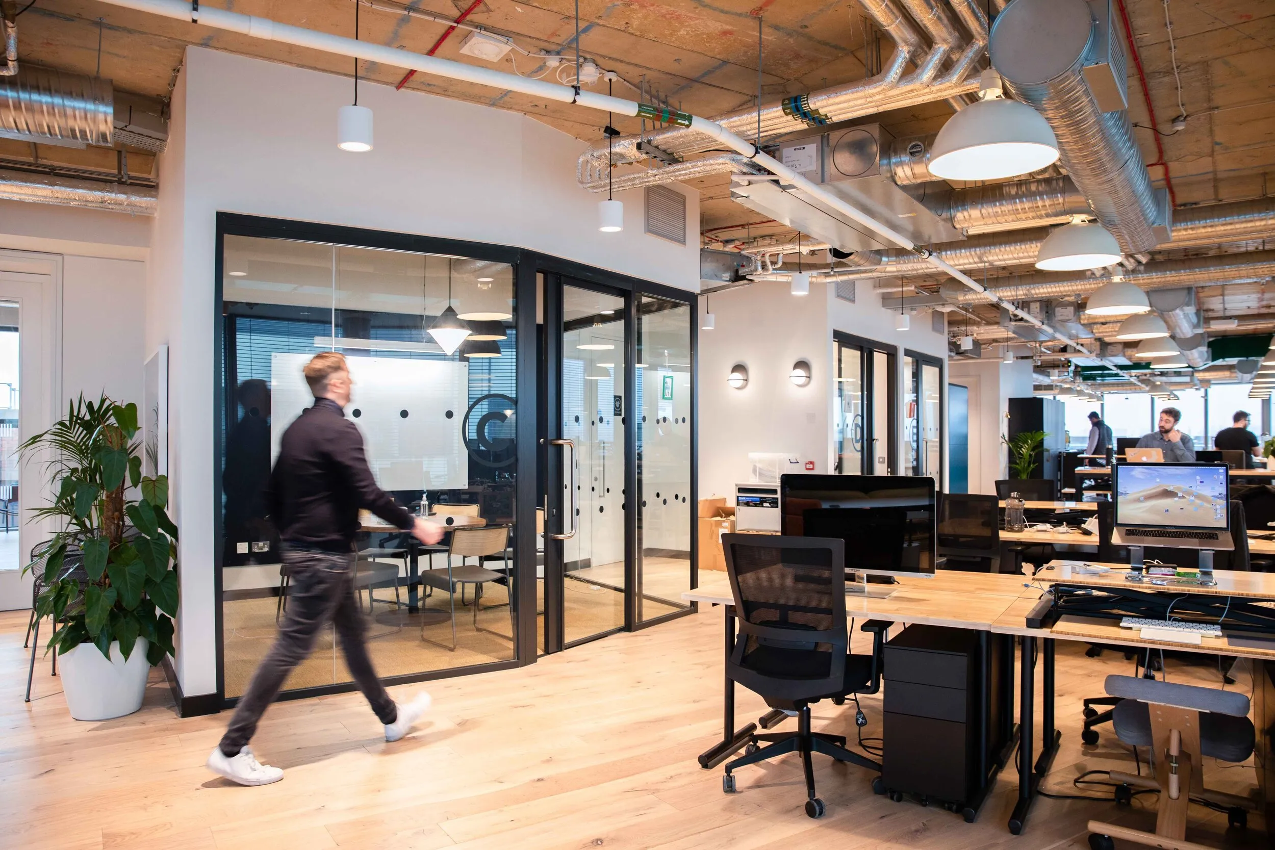 Modern tech office interior with glass meeting room, corporate workplace photography, London