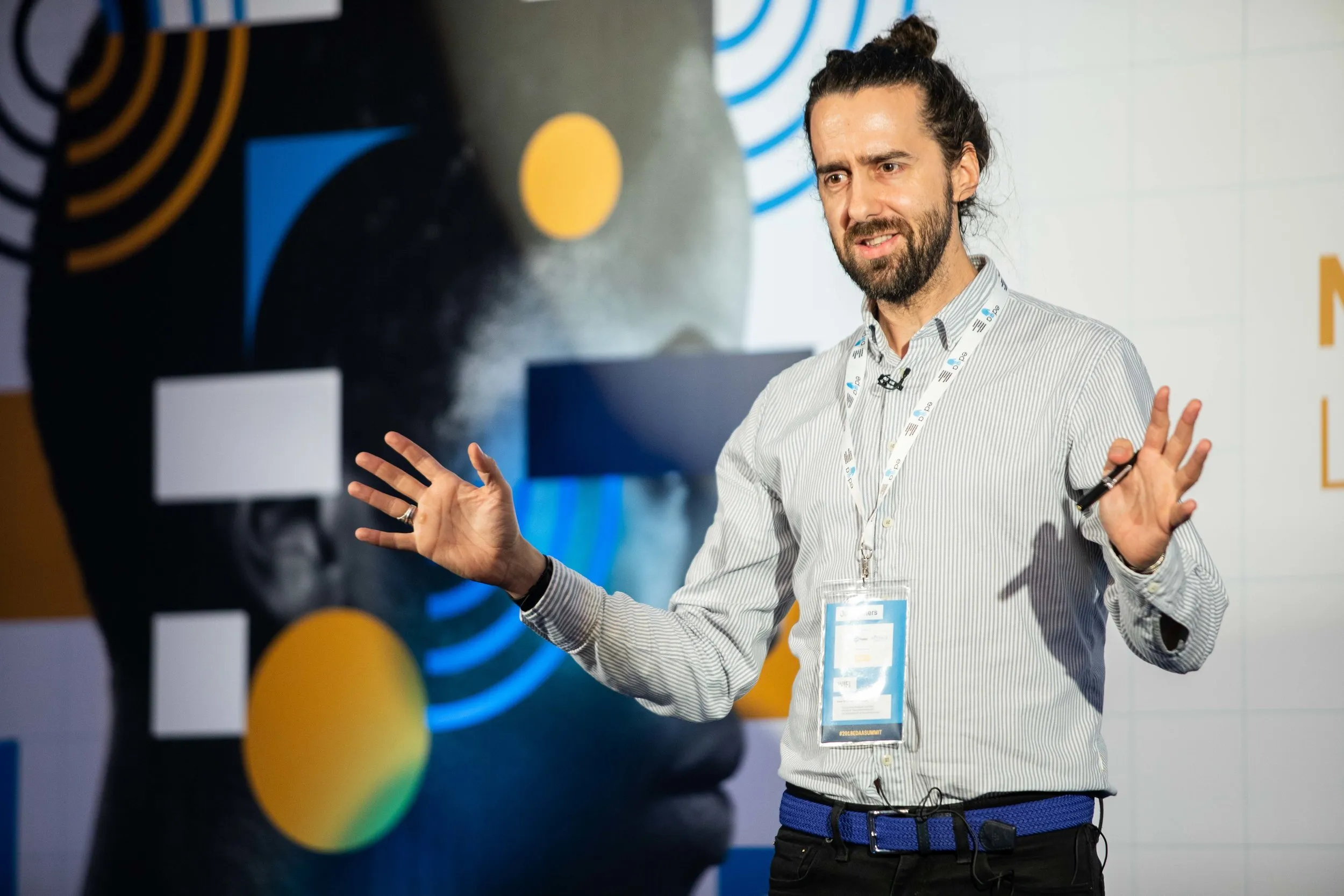 Keynote speaker on stage at a branded corporate conference, London conference photography