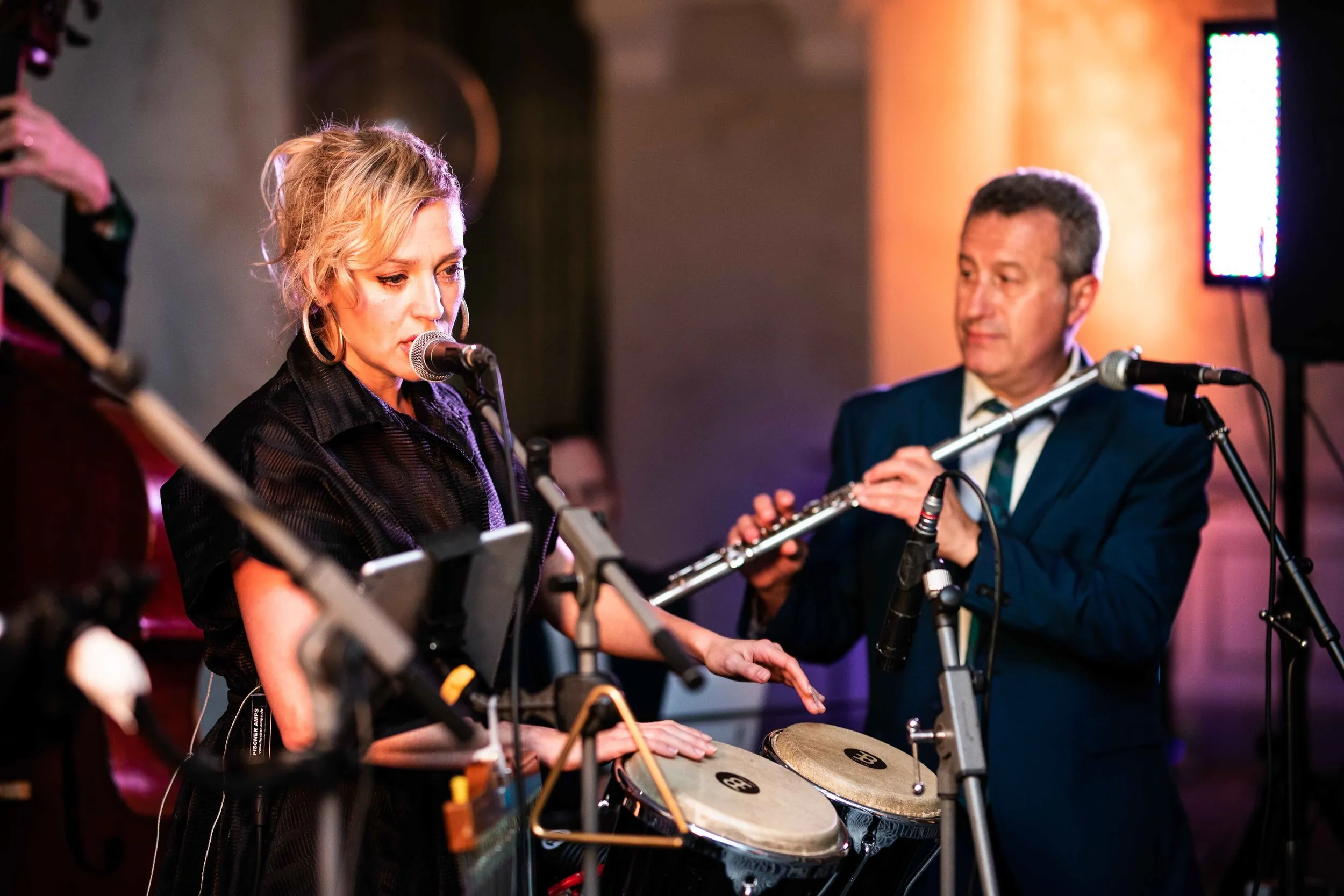 Live jazz band performing at a corporate gala with bongo and flute, London