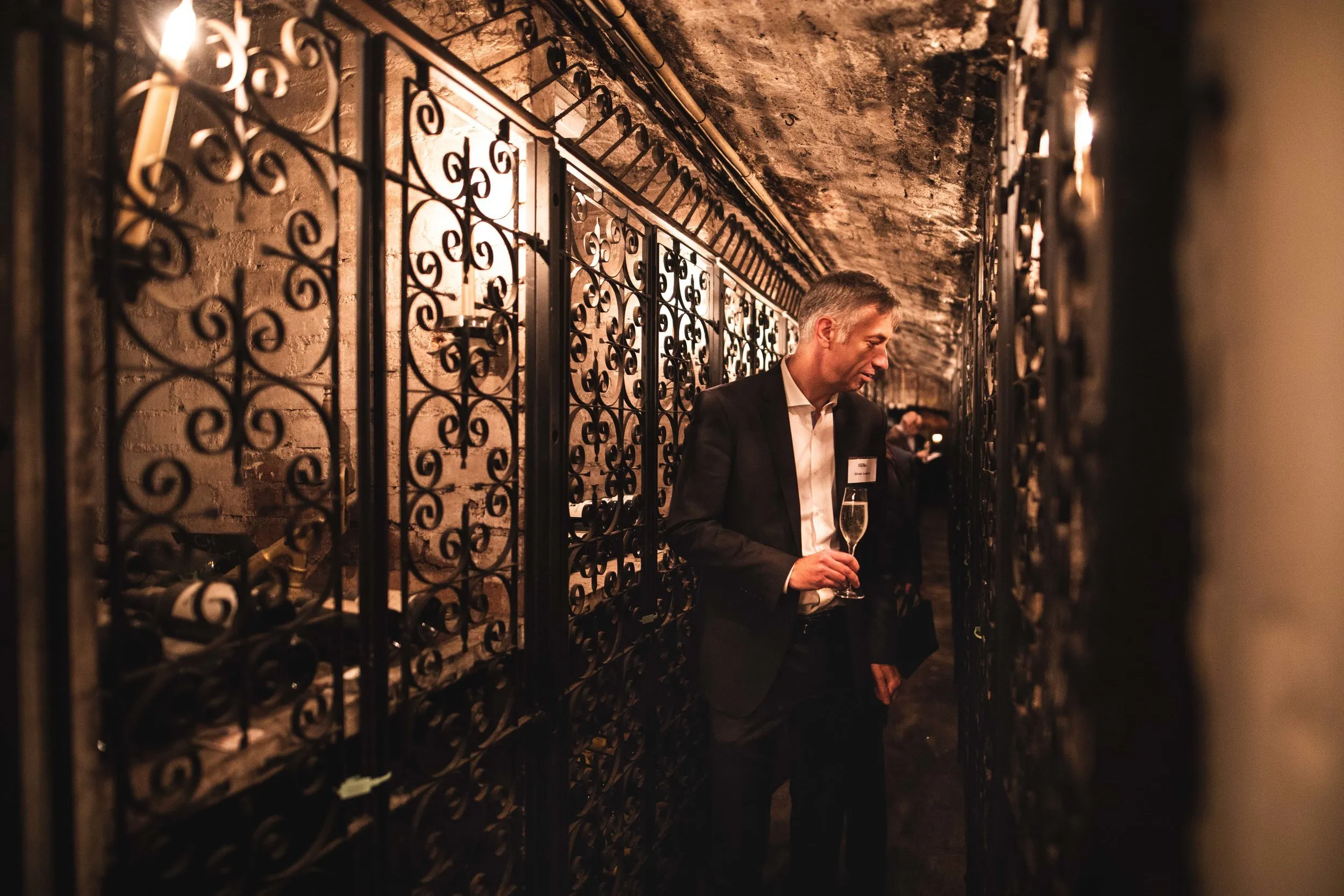 Networking drinks in a luxury wine cellar venue, London corporate event photography