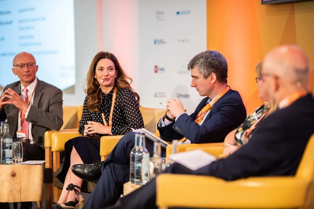 Panel discussion on armchairs at an investment conference, London conference photography