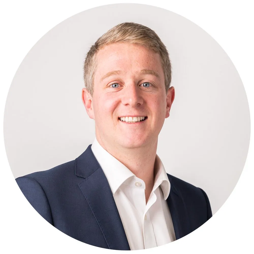 Corporate headshot of blonde man in navy blazer, London
