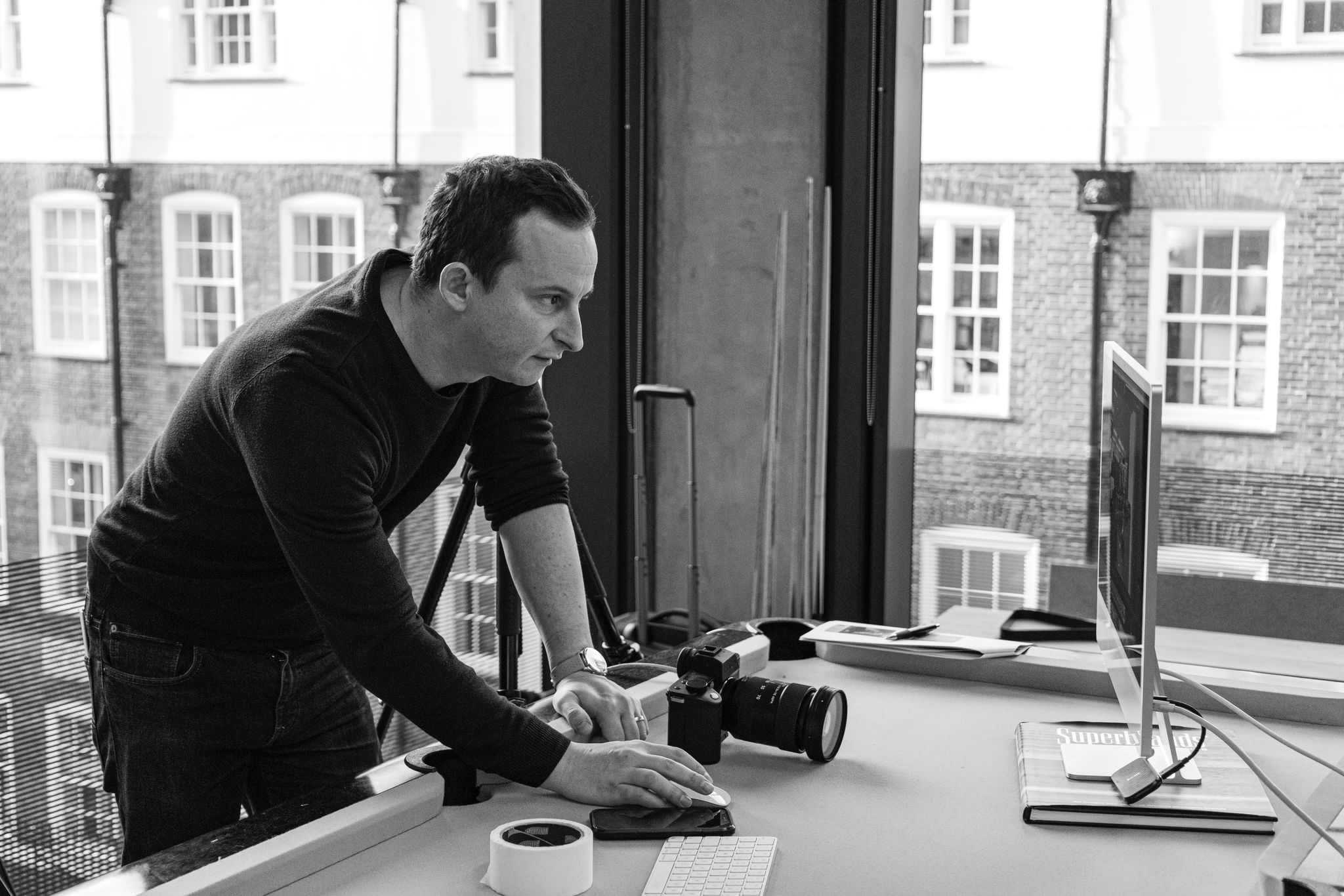 David McConaghy reviewing images on monitor during Sharp Electronics corporate lifestyle photography shoot, London