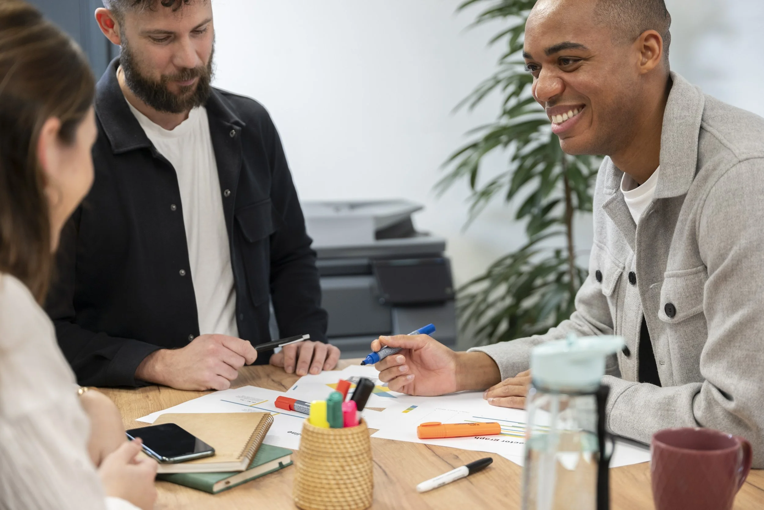 Final delivered image — Sharp Electronics campaign shoot, three colleagues in natural meeting scene with printer in background, London